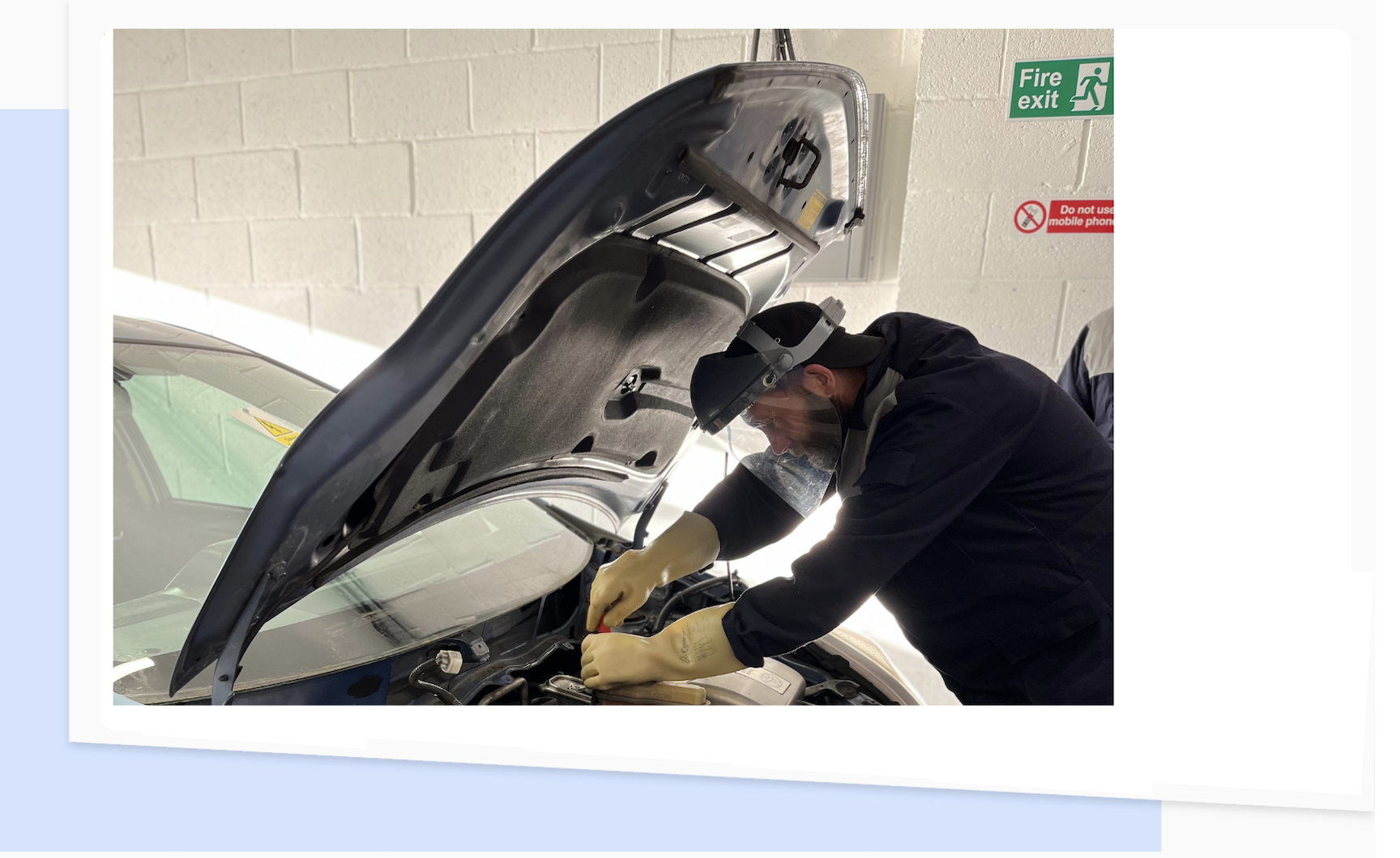 A Technician Checking Under The Bonnet Of A Hybrid and Electric Vehicle